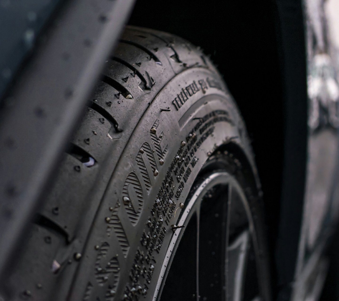 Close-up of a wet tire tread and wheel